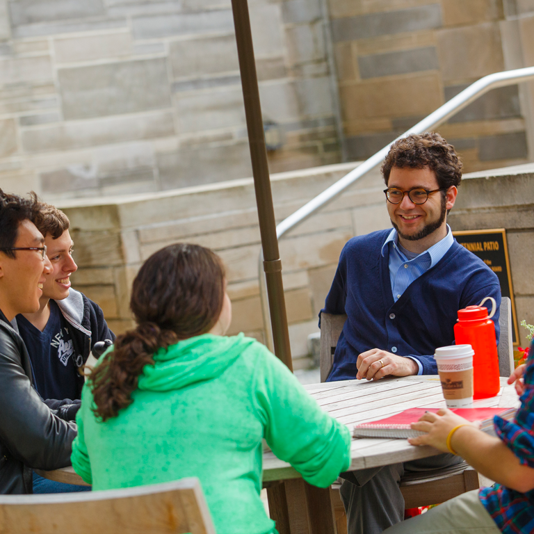 Students workshop together at a table outside the IMU.